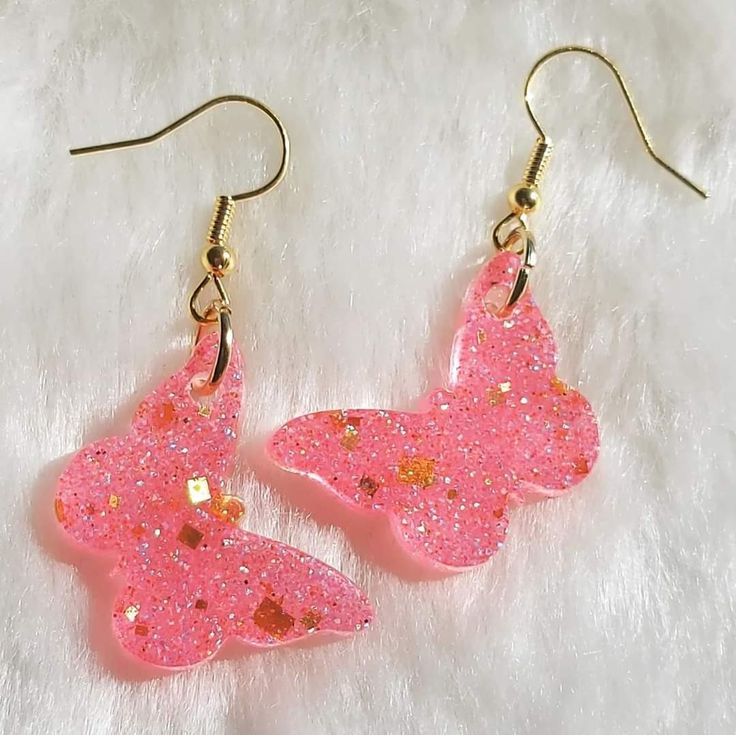 Brincos de borboleta em resina rosa com glitter dourado